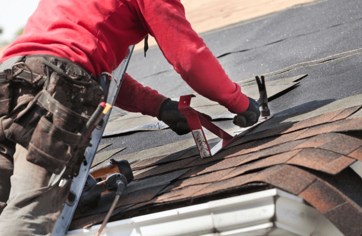 Professional roofer repairing damaged shingles in La Quinta, CA