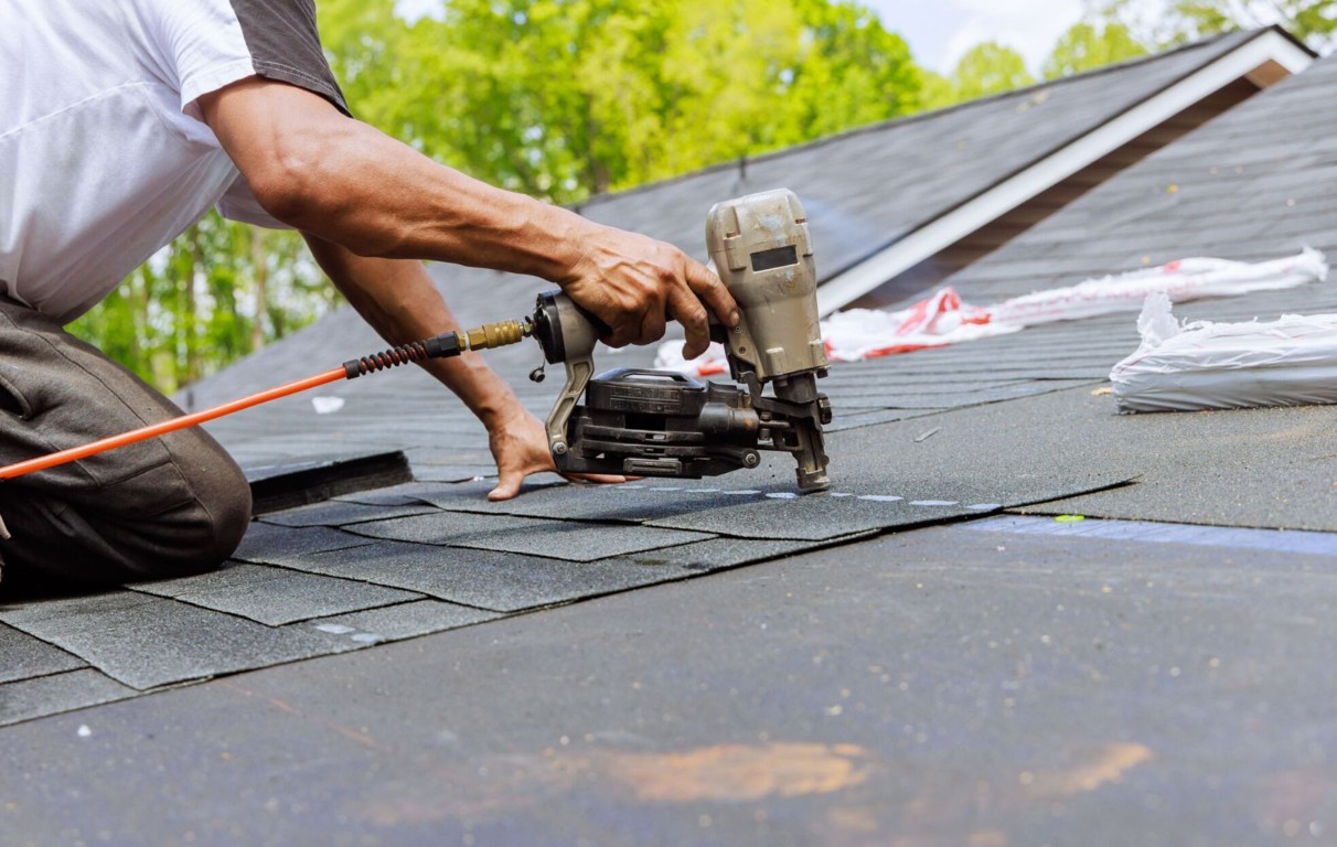 Expert installation of asphalt roofing shingles on residential home